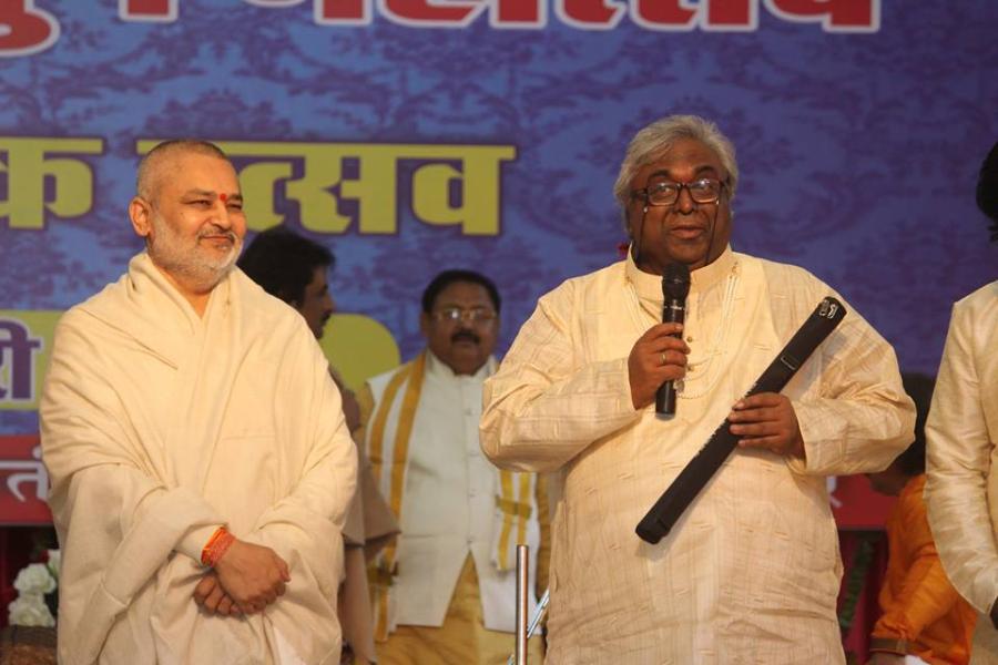 Pundit Amarnath Ji is presenting flute to Brahmachari Girish Ji