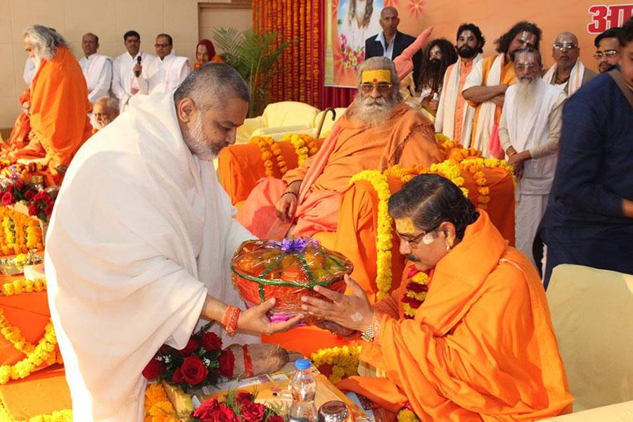 Brahmachari Shri Girish Ji is presenting fruits to Swami Jitendranath Ji during Maharishi Birth Centenary Year Fulfillment Celebration Bhopal